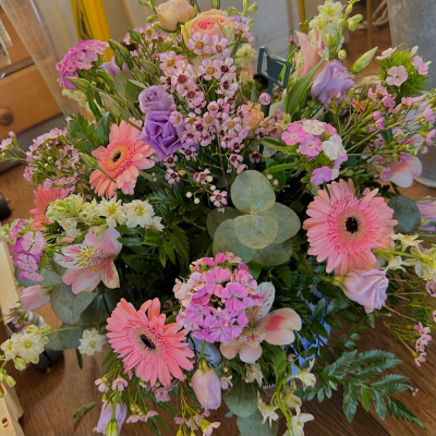 Romantic Rose Garden Arrangement - A beautiful mix of pink flowers and lush greenery. This arrangement brings the romance of a rose garden to any space.