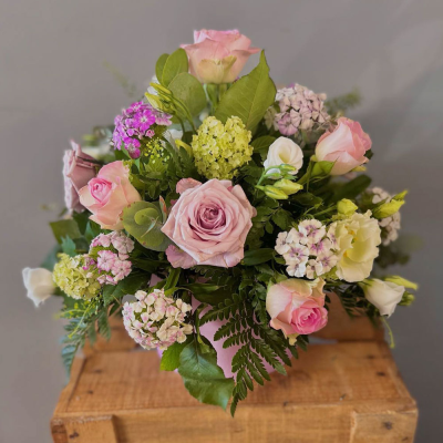 A New Day - A delightful pot filled with pastel-colored blooms. Perfect for adding a touch of colour to any home.