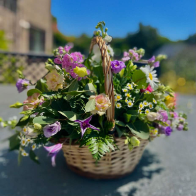 Vibrant Celebration Basket - A lively basket with bright and colorful flowers, ideal for celebrations and joyful moments.